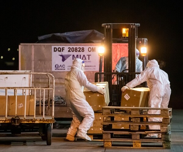 workers unload crates
