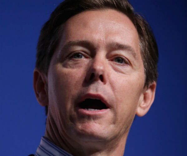 ralph reed speaks in front of a blue background