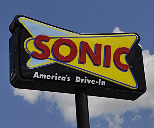 Sonic fast food drive restaurant chain sign in blue sky