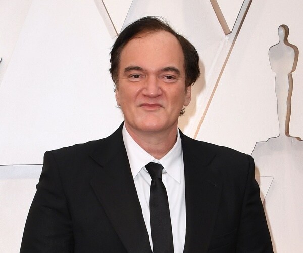 quentin tarantino stands on red carpet