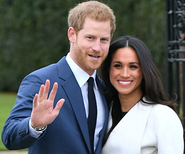 prince harry waves while being photographed with her wife megan markle