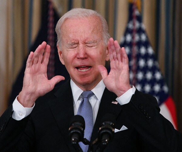 joe biden closes eyes and holds up hands