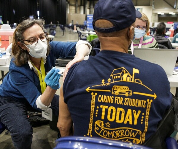 man gets vaccine shot in arm