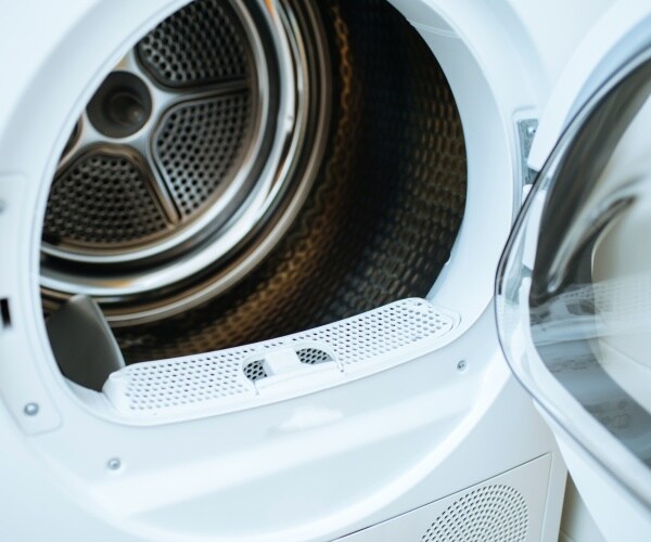 an empty clothes dryer is shown with the door open