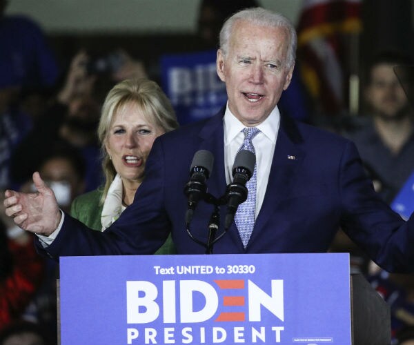 joe biden is shown with wife jill in the background