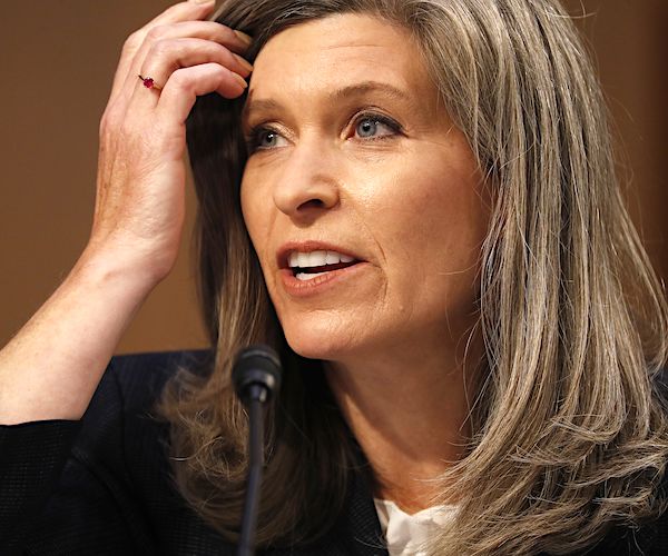 joni ernst brushes her hair away from her face with her right hand while speaking during the senate judiciary hearing