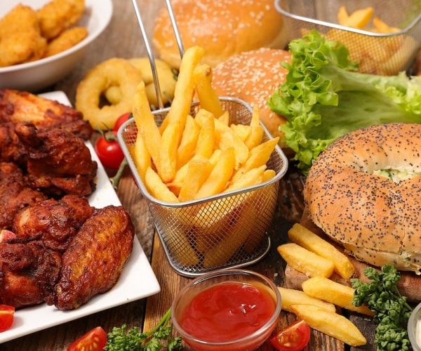 spread of ultra-processed foods including chicken wings, bagel, fires