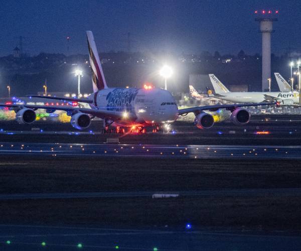 night view of airplanes lined up on the tarmac