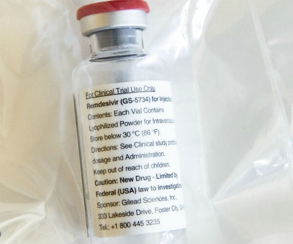 An ampoule of the drug Remdesivir is on the table during a press conference