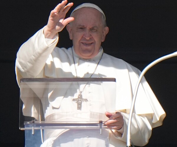 Pope Francis delivers his blessing from the window of his studio overlooking St. Peter's Square at the Vatican