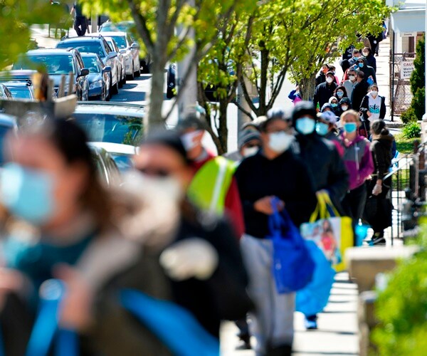 people line up for food in mass.