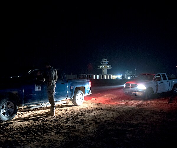 members of the military wait outside facilities at Al Assad Air Base, Iraq