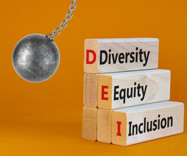 a wrecking ball about to knock down blocks reading diversity equity inclusion