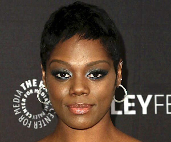 Afton Williamson stands on the red carpet, posing for a photo