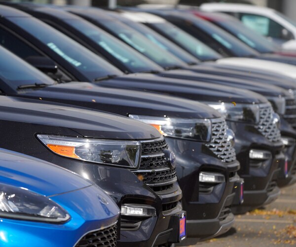 a row of sport utility vehicles at a ford dealership