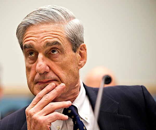 robert mueller rests his chin in his right hand during congressional testimony