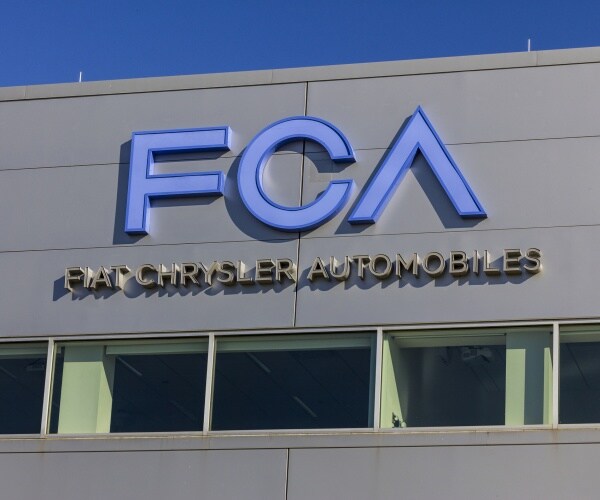 fiat chrysler logo is shown on a building in blue lettering