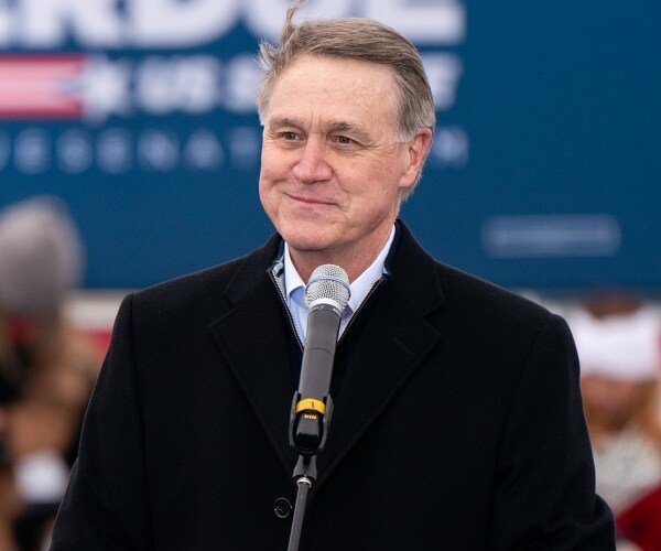 david perdue stands on stage