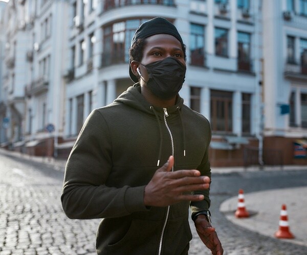 man running and wearing face mask