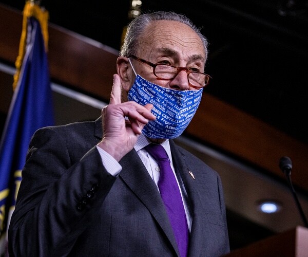 chuck schumer speaks from podium