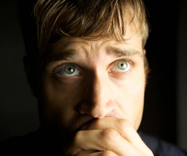 studio photo of worried young man
