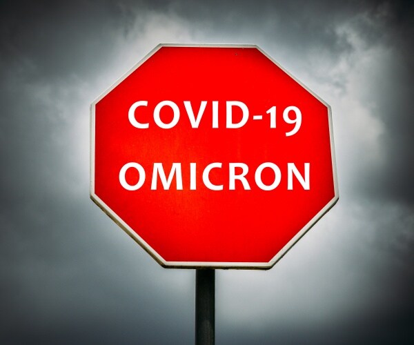COVID-19 Omicron written on stop sign