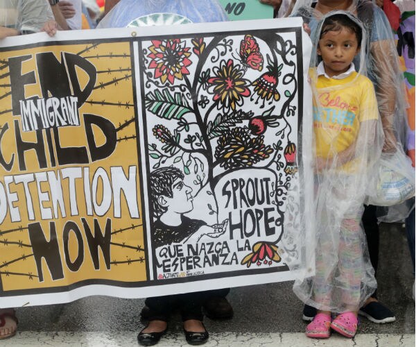 a little girl stands outside a florida shelter during a protest
