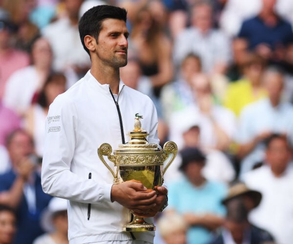 Novak Djokovic holds the winning trophy