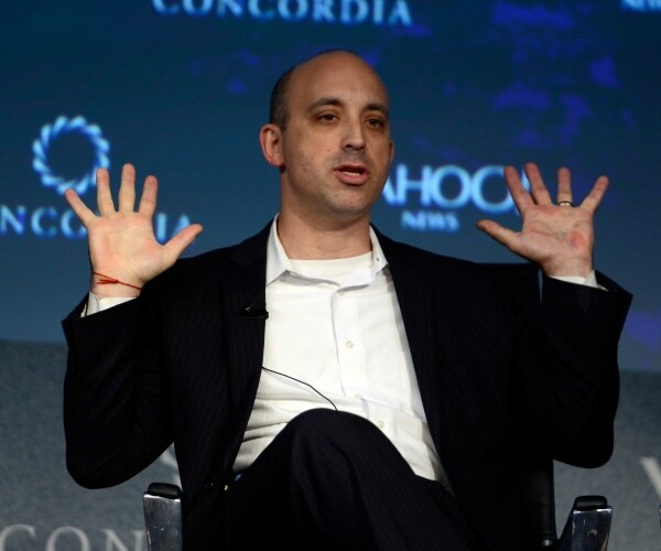 jonathan greenblatt speaking with his hands up wearing a black suit and white shirt