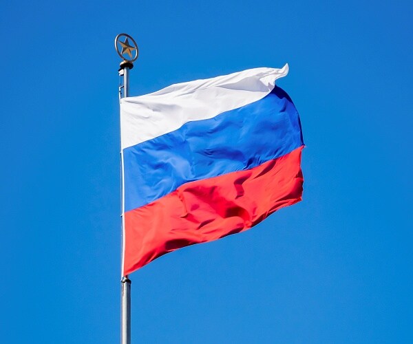 russian flag flies in wind