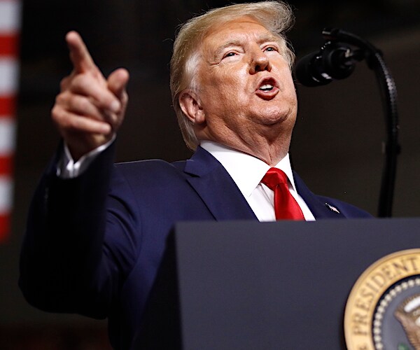 president donald trump points to his right while delivering a campaign rally speech