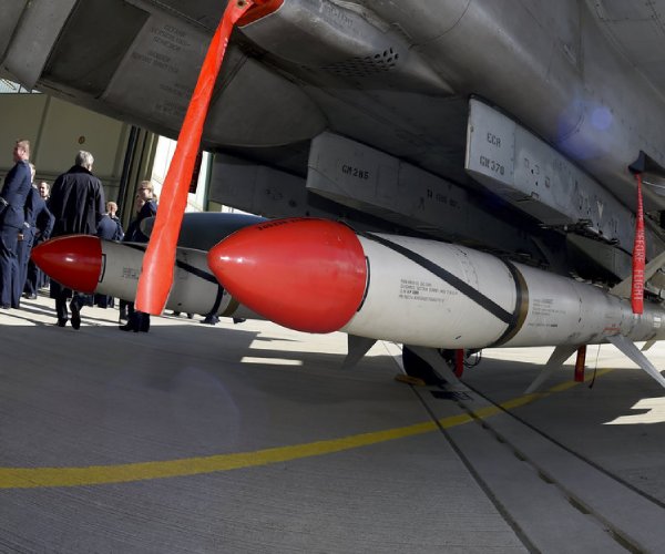 agm-88 high speed anti-radiation missiles are attached to a fighter jet