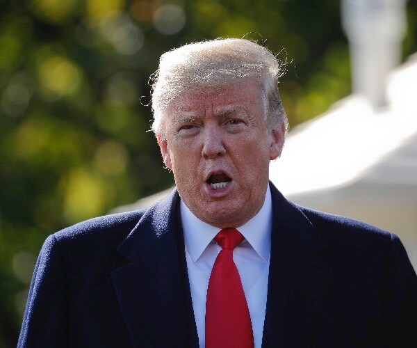 president donald trump stops to talk to the media before walking across the south lawn of the white house. 