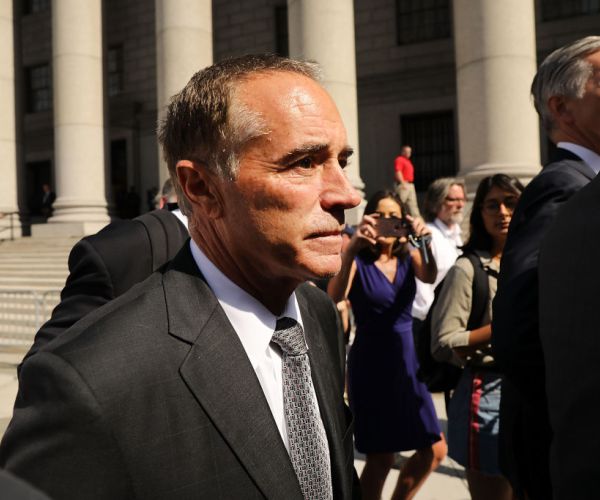 rep. chris collins walks out of a new york courthouse.