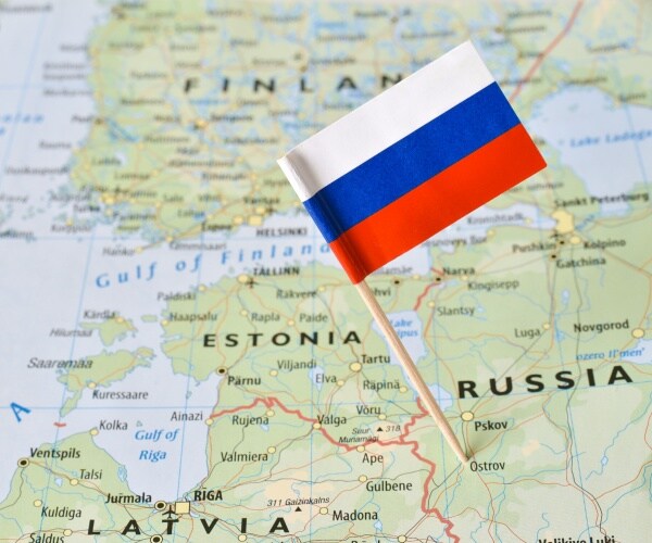 closeup shot of russia flag pin on map bordering with the baltic countries