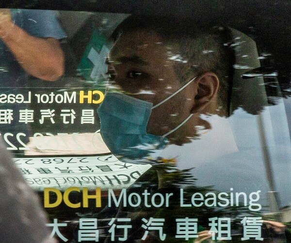 man arrives to court in car