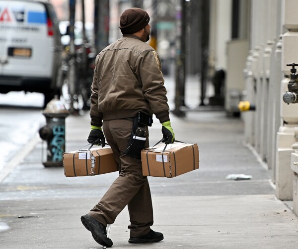 a ups driver delivers packages in new york city