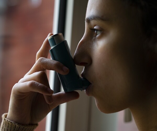 woman using inhaler