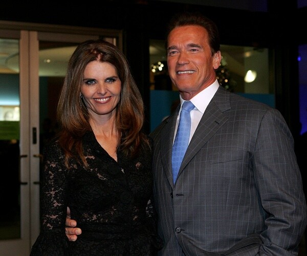 arnold schwarzenegger and maria shriver stand for photo