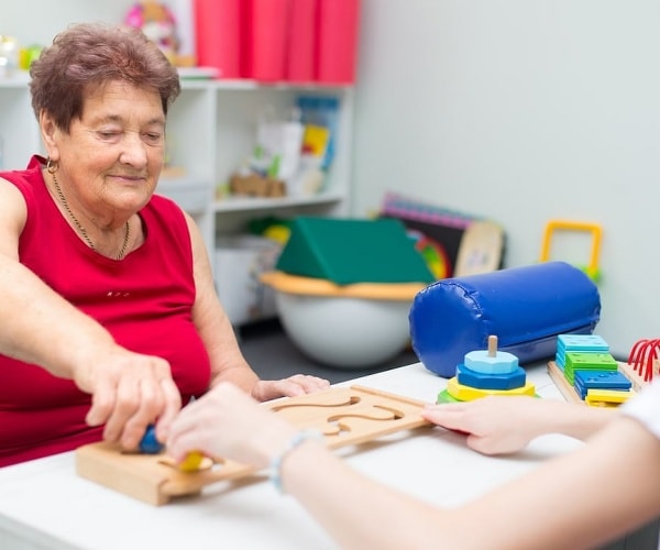 woman who had a stroke doing rehabilitation therapy 
