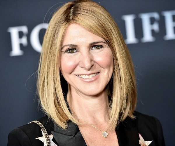 alison greenspan stands on red carpet