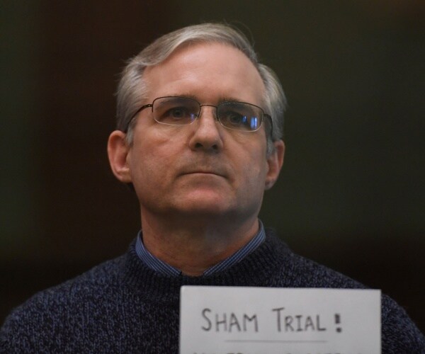 paul whelan stands in defendants cage