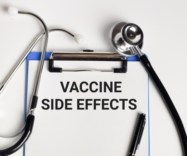 clipboard with paper that says 'Vaccine Side Effects' with stethoscope and pen