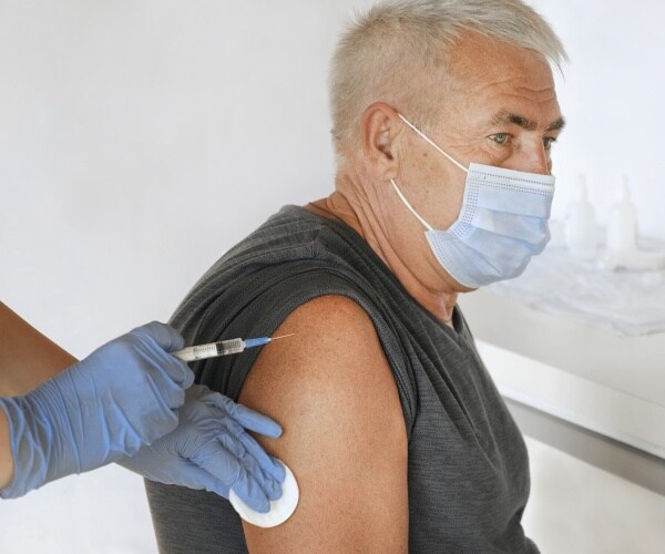 older man getting COVID vaccine