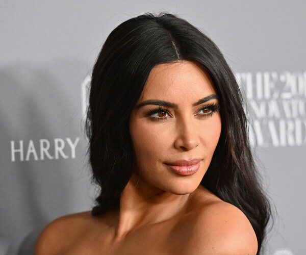 kim kardashian stands on red carpet