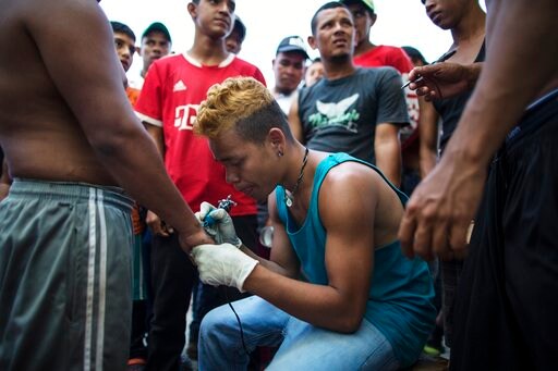 Caravan Artist Tattoos Loved Ones' Names for Fellow Migrants