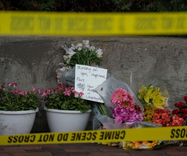 flowers are left for victims of the july fourth mass shooting in downtown highland park Illinois 