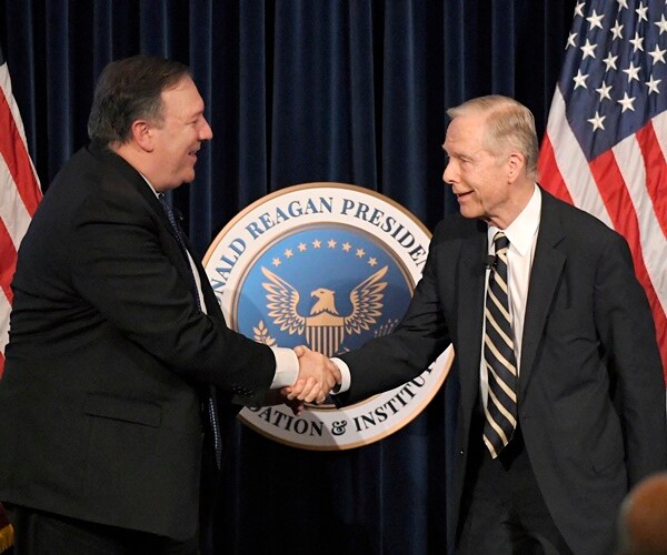 pete wilson shakes mike pompeo's hand at the reagan presidential library