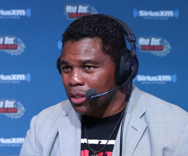 walker in a t shirt and light gray blazer