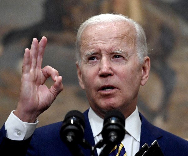 joe biden making the oh kay sign with his hand as he speaks at a press conference